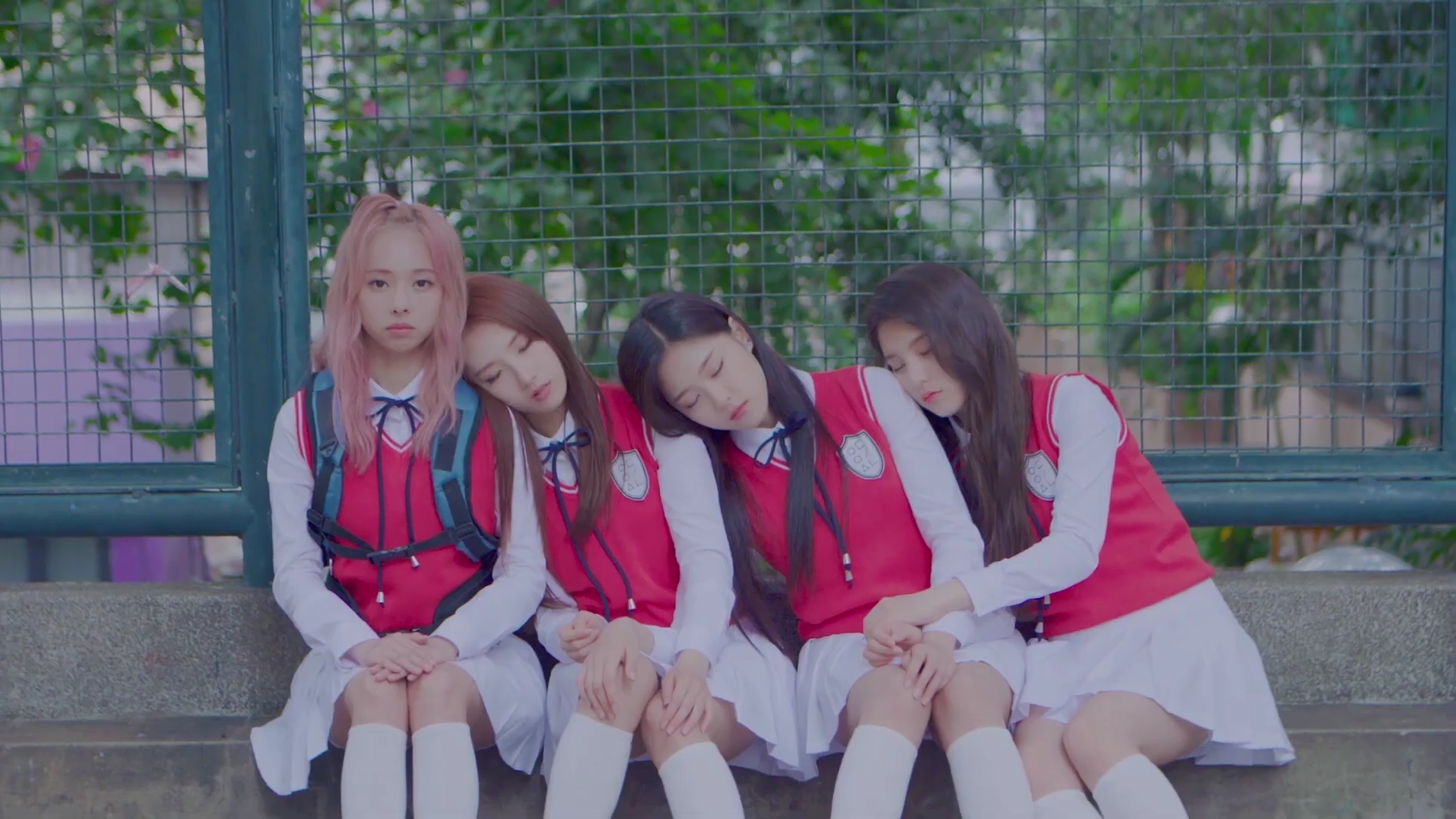 Vivi, Haseul, Hyunjin, and Heejin in red school uniforms, from the 'You and Me Together' music video.